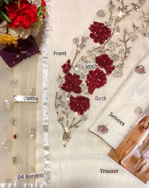 Maria B organza suit featuring tie & dye embroidery with handwork, cutwork daman, and a beautifully detailed dupatta with tassels.